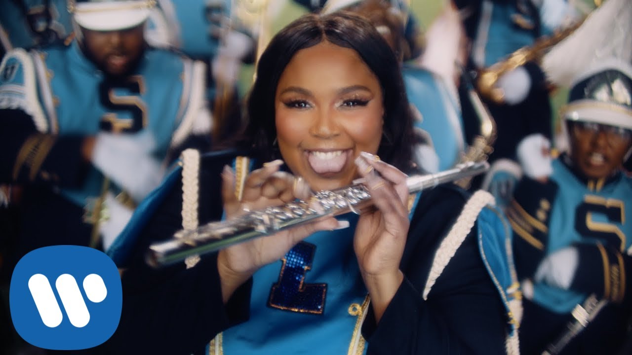 From the ‘Good As Hell’ music video: Lizzo, holding a flute, leads a marching band